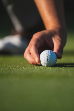 Golfer placing golf ball